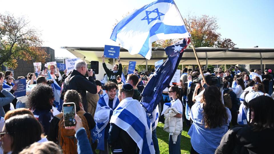 Members of the Jewish community gathered outside Melbourne uni.