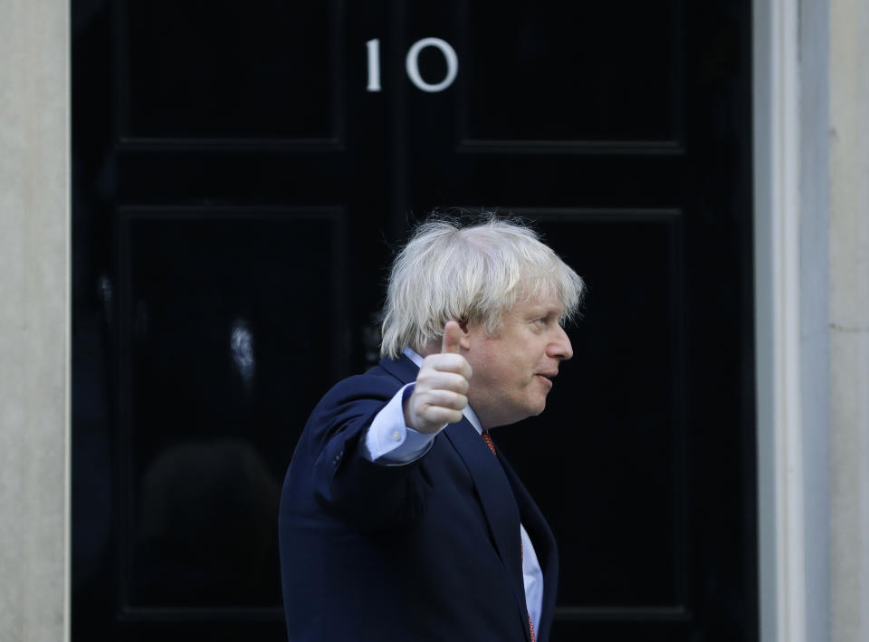 Britain's Prime Minister Boris Johnson gestures after applauding on the doorstep of 10 Downing Street, during the weekly "Clap for our Carers", in London, Thursday, May 28, 2020. The COVID-19 coronavirus pandemic has prompted a public display of appreciation for care workers. The applause takes place across Britain every Thursday at 8pm local time to show appreciation for healthcare workers, emergency services, armed services, delivery drivers, shop workers, teachers, waste collectors, manufacturers, postal workers, cleaners, vets, engineers and all those helping people with coronavirus and keeping the country functioning while most people stay at home in the lockdown. (AP Photo/Kirsty Wigglesworth)