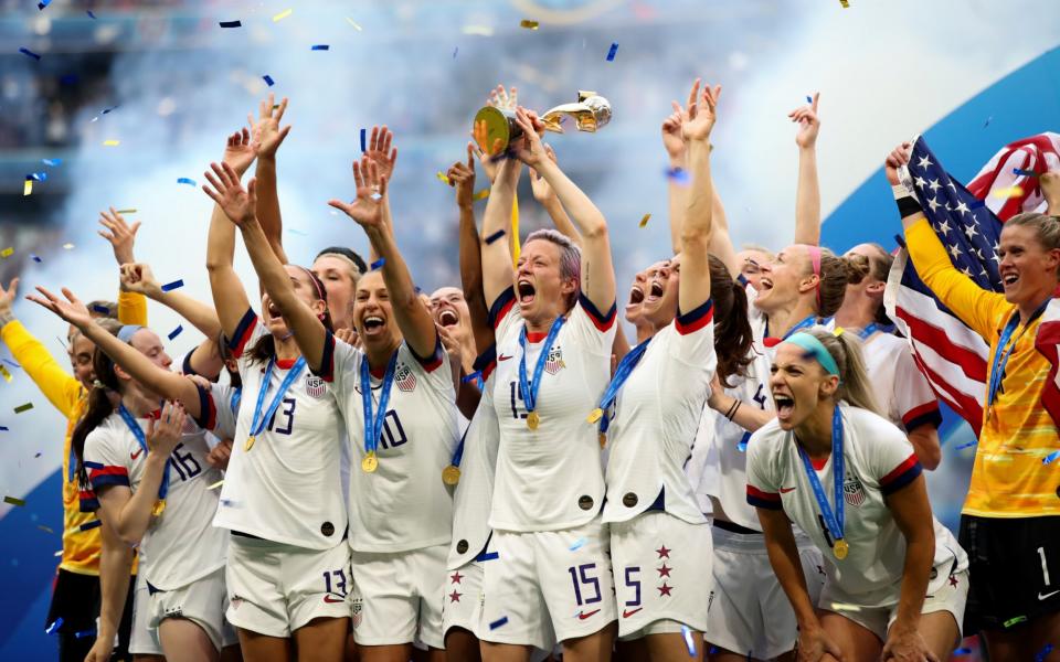 Megan Rapinoe and USA players celebrate as they lift the trophy during the 2019 FIFA Women's World Cup - GETTY IMAGES