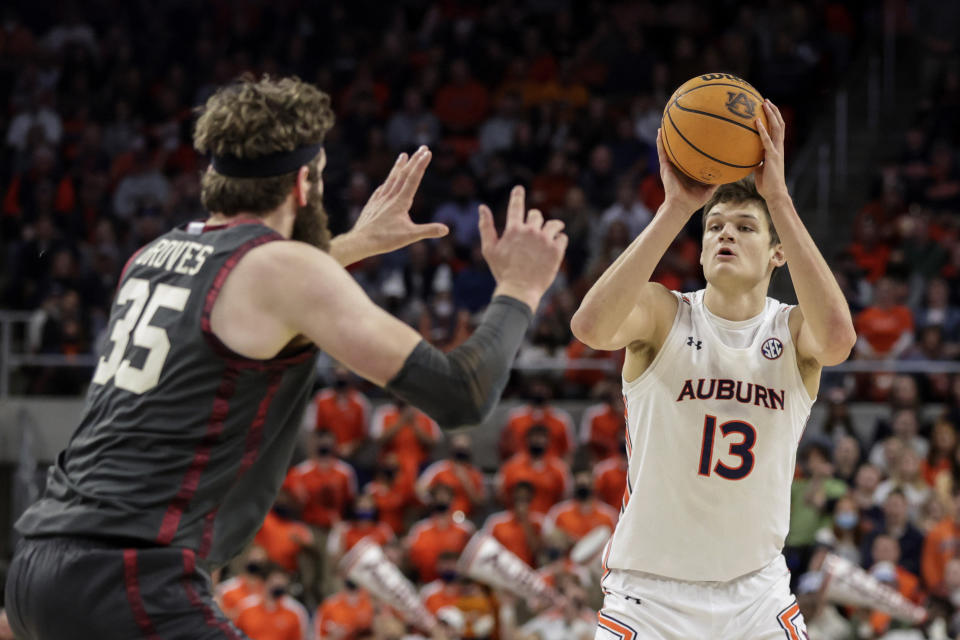 Auburn forward Walker Kessler (13) shoots a three pointer as Oklahoma forward Tanner Groves (35) defends during the second half of an NCAA college basketball game Saturday, Jan. 29, 2022, in Auburn, Ala. (AP Photo/Butch Dill)