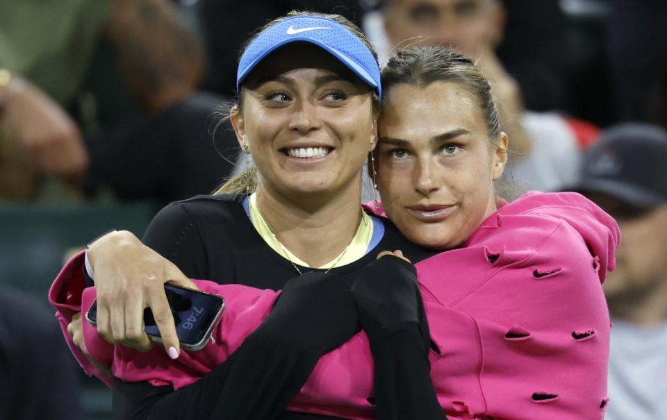 Paula Badosa of Spain (L) and Aryna Sabalenka of Belarus (R) embrace during the Eisenhower Cup mixed doubles event at the BNP Paribas Open tennis tournament at the Indian Wells Tennis Garden in Indian Wells, California