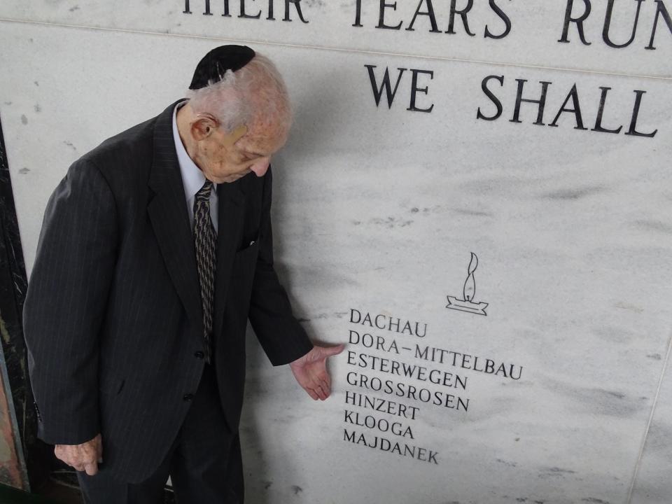 At Eternal Light Memorial Gardens, west of Boynton Beach, Norman Frajman points to the name of a concentration camp, Majdanek, where he spent time during the Holocaust.