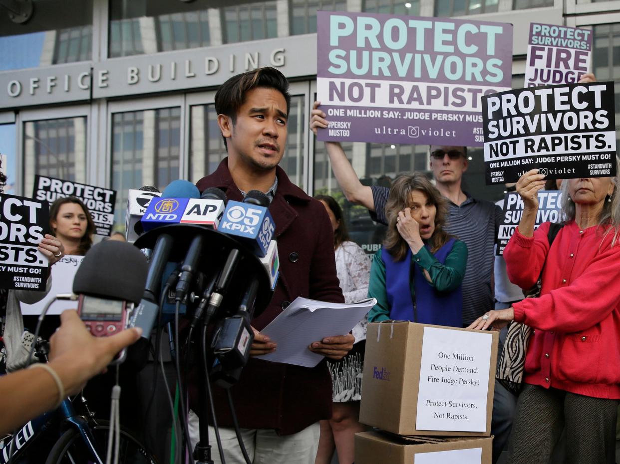 Sexual assault survivor Chris Huqueriza speaks at a rally before over one million signatures were delivered to the California Commission on Judicial Performance calling for the removal of Judge Aaron Persky from the bench Friday, June 10, 2016, in San Francisco. A group of California lawmakers joined women's rights advocates Friday in urging a California agency to take action against the judge who sentenced a former Stanford University swimmer to six months in jail for sexually assaulting an unconscious woman. (AP Photo/Eric Risberg)