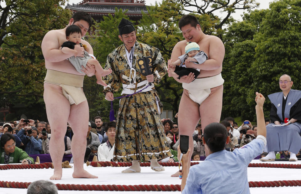 An unidentified baby, held by a college sumo wrester, cries during Naki Sumo, or Crying Baby Contest, as a judge looks on at Sensoji temple in Tokyo Monday, April 29, 2013. The babies born in 2012 participated in the annual traditional ritual performed as a prayer for their healthy growth.