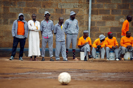 Prisoners wait for the start of a mock world cup soccer match between Russia and Saudi Arabia, as part of a month-long soccer tournament involving eight prison teams at the Kamiti Maximum Prison, Kenya's largest prison facility, near Nairobi, Kenya, June 14, 2018. REUTERS/Baz Ratner