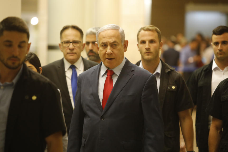 Israeli Prime Minister Benjamin Netanyahu walks in the Knesset, Israel's parliament in Jerusalem, Wednesday, May 29, 2019. Israeli Prime Minister Benjamin Netanyahu faced a deadline at midnight Wednesday to form a new governing coalition as he tried to stave off a crisis that could trigger an unprecedented second election this year or even force the longtime leader to step down. (AP Photo/Sebastian Scheiner)