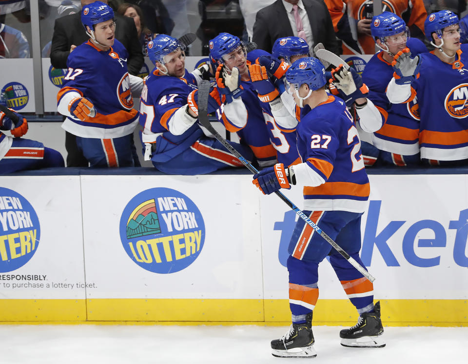 Teammates congratulate New York Islanders left wing Anders Lee (27) after Lee scored a goal against the Colorado Avalanche during the third period of an NHL hockey game, Monday, Jan. 6, 2020, in Uniondale, N.Y. The Islanders defeated the Avalanche 1-0 on Lee's goal. (AP Photo/Kathy Willens)