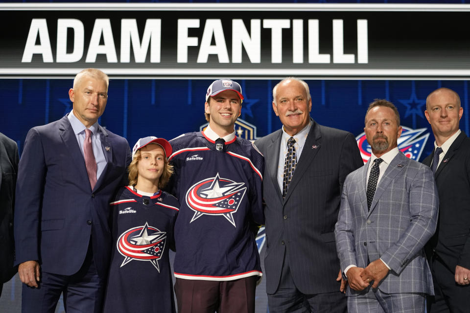 Adam Fantilli, center, poses with Columbus Blue Jackets officials after being picked by the team during the first round of the NHL hockey draft Wednesday, June 28, 2023, in Nashville, Tenn. (AP Photo/George Walker IV)