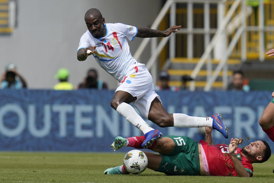 DR Congo's Gael Kakuta, left, and Morocco's Selim Amallah challenge for the ball during the African Cup of Nations Group F soccer match between Morocco and DR Congo, at the Laurent Pokou stadium in San Pedro, Ivory Coast, Sunday, Jan. 21, 2024. (AP Photo/Themba Hadebe)