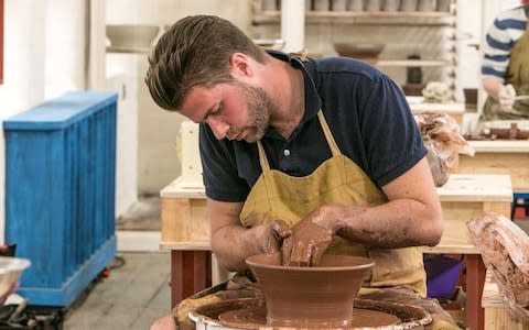 A contestant molding on The Great British Pottery Throwdown