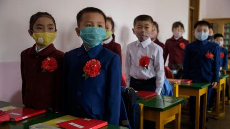 North Korean children wearing face masks against COVID-19 attend class on June 3 in Pyongyang.