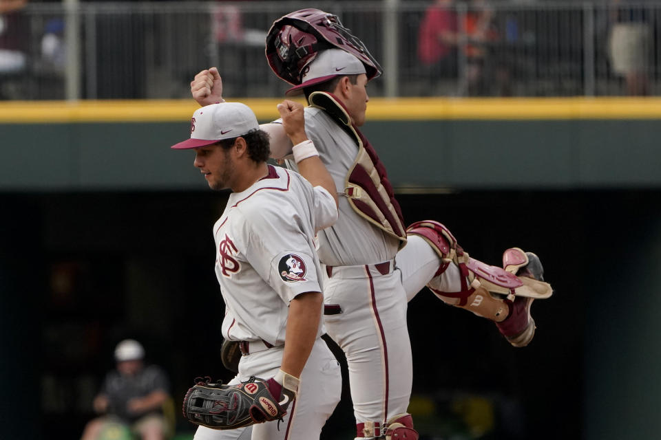 Florida State left fielder Elijah Cabell, left, and catcher Matheu Nelson celebrate the team's win against Miami in an NCAA college baseball game at the Atlantic Coast Conference tournament Friday, May 28, 2021, in Charlotte, N.C. (AP Photo/Chris Carlson)