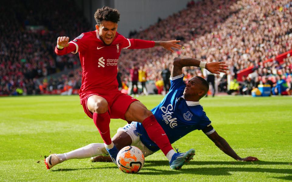 Liverpool's Luis Diaz, left, challenges for the ball with Everton's Ashley Young