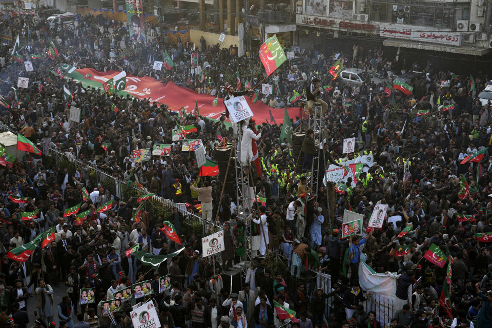 Supporters of Pakistan's former Prime Minister Imran Khan's 'Pakistan Tehreek-e-Insaf' party attend a rally, in Rawalpindi, Pakistan, Saturday, Nov. 26, 2022. Khan said Saturday his party was quitting the country's regional and national assemblies, as he made his first public appearance since being wounded in a gun attack earlier this month. (AP Photo/Anjum Naveed)