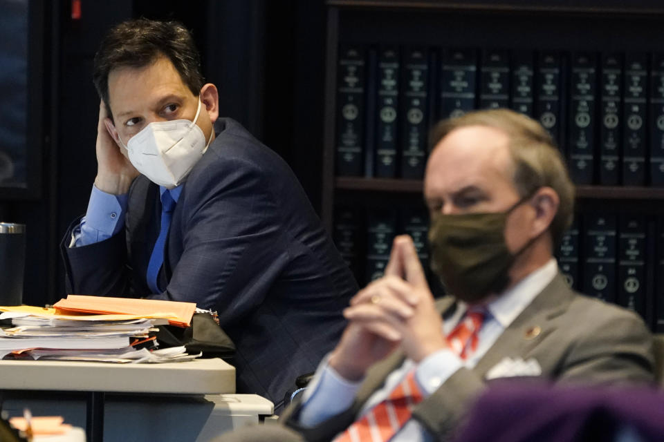 Virginia State Sen. Scott Surovell, D-Fairfax, left, listens along with Sen. Lynwood Lewis, D-Accomack, right, during debate on a bill calling for the removal of the statue of former Sen. Harry Byrd from Capitol Square during the Senate session at the Science Museum of Virginia in Richmond, Va., Tuesday, Feb. 23, 2021. (AP Photo/Steve Helber)