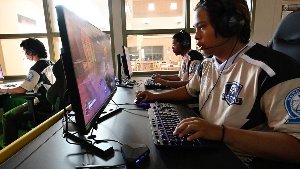 Ewan McIntyre and other members of the Enochs esports team play an Overwatch match against Tracy High School at Enochs High School in Modesto, Calif., Tuesday, Sept. 19, 2023.