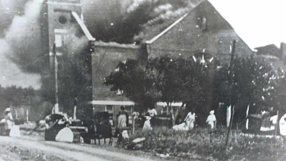 Mt. Zion Baptist Church burns after being torched by white mobs during the 1921 Tulsa race riot. - Greenworld Cultural Center/Tulsa World/AP