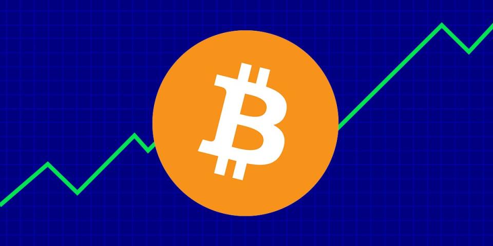 Bitcoin logo in front of an ascending line chart