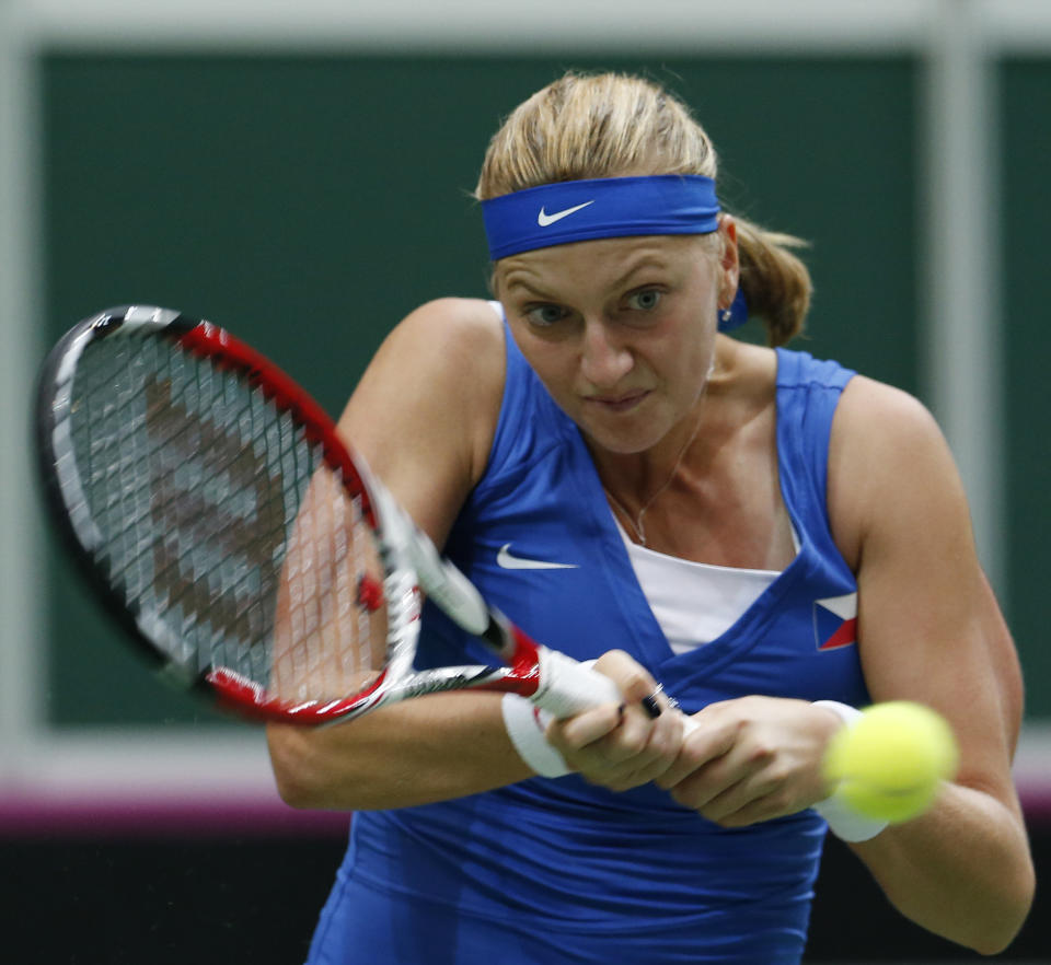 Czech Republic's Petra Kvitova returns a ball to Italy's Camila Giorgi during their Fed Cup semifinal tennis match in Ostrava, Czech Republic, Saturday, April 19, 2014. (AP Photo/Petr David Josek)