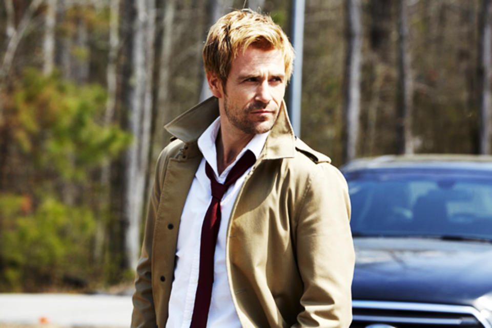 Matt Ryan, wearing a trench coat over an untucked shirt with a loosened tie, stands outdoors near a car looking into the distance