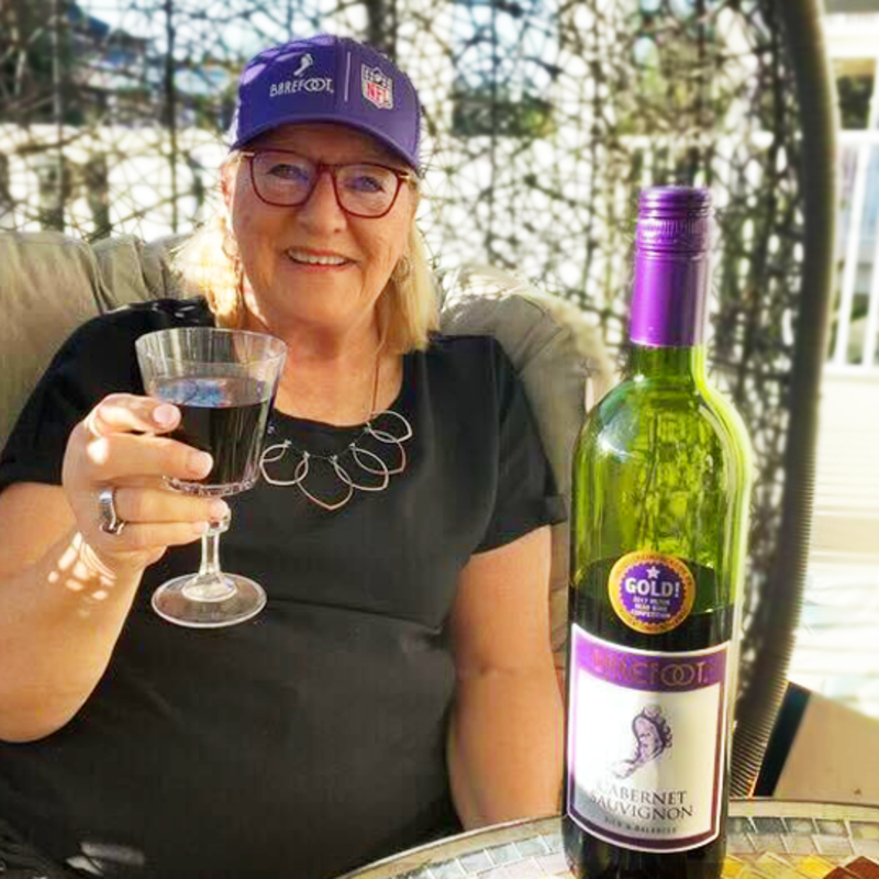 Donna Kelce drinking a glass of Barefoot's Cabernet Sauvignon.<p>Barefoot Wine</p>
