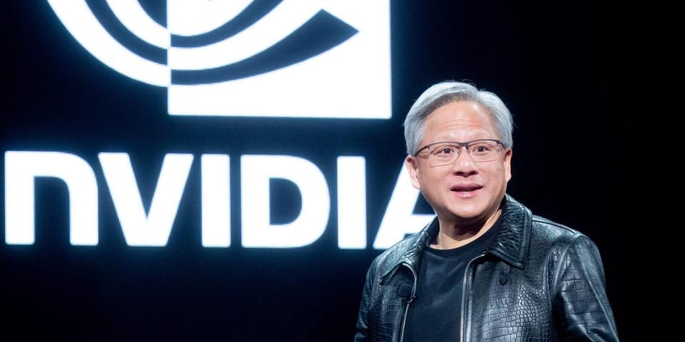 Jensen Huang in front of the Nvidia logo.