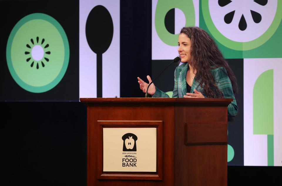 Akron-Canton Regional Foodbank Vice President Katie Carver Reed tells the audience about her food struggles growing up during the Harvest for Hunger campaign kickoff breakfast Tuesday at the John S. Knight Center in Akron.
