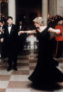 It wouldn't be a royal tour retrospective without a photograph of Princess Diana dancing with John Travolta. For a starry evening at the White House, the royal wore a Victor Edelstein cold-shoulder gown which fetched for £240,000 at auction in 2013. <em>[Photo: Getty]</em>