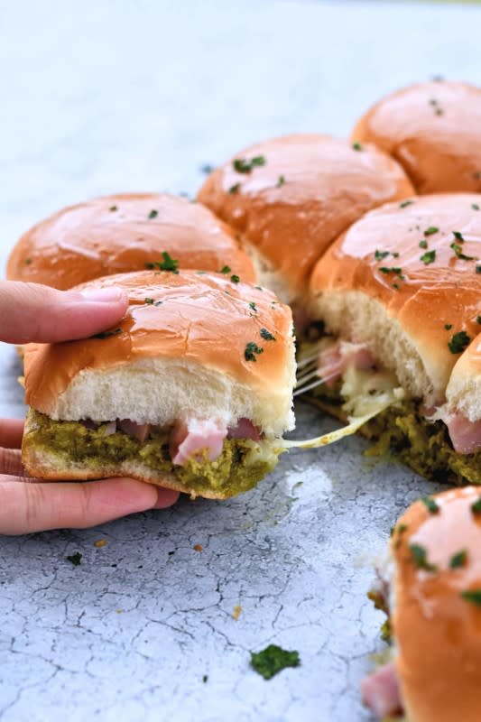 <p>24 Bite</p><p>Easy, cheesy and delicious, but unlike your usual sliders, bursting with the fresh flavor of pesto.</p><p><strong>Get the recipe: <a href="https://24bite.com/how-to-make-ham-and-cheese-sliders/" rel="nofollow noopener" target="_blank" data-ylk="slk:Ham and Cheese Sliders with Pesto;elm:context_link;itc:0;sec:content-canvas" class="link rapid-noclick-resp">Ham and Cheese Sliders with Pesto</a></strong></p>