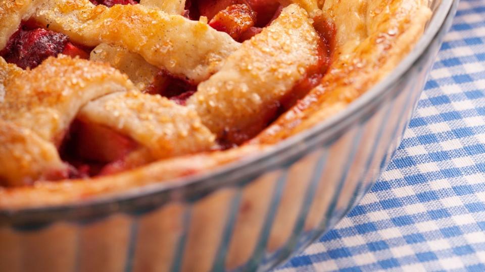 apple raspberry pie with a lattice crust and in a glass pie dish