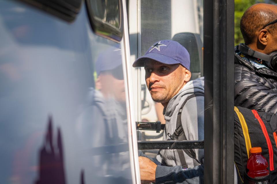 A man is seen boarding a bus.