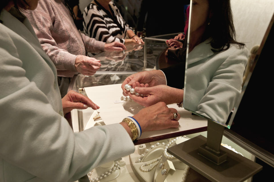 A $376,000 necklace of cultured pearls from Australia is shown to a shopper at the Berkshire-owned Borsheims jewelry store in Omaha, Neb., Friday, May 4, 2012. Berkshire Hathaway is expected to have 30,000 shareholders come to Omaha for it's annual shareholders meeting this weekend. (AP Photo/Nati Harnik)