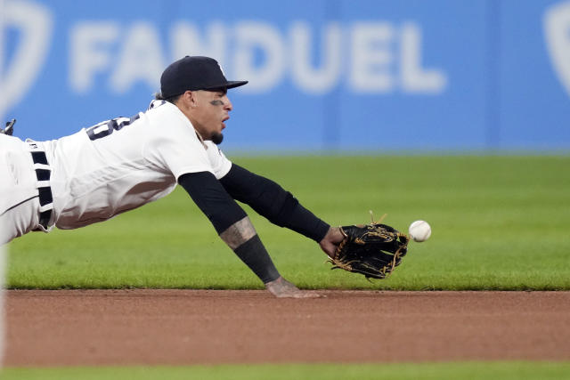 Detroit Tigers shortstop Javier Baez (28) throws a ball to fans