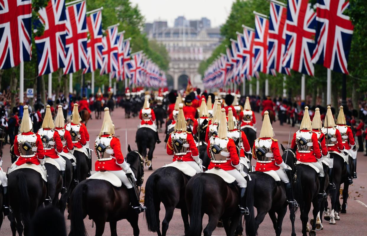 Members of the Household Cavalry travel along The Mall to the Trooping the Colour ceremony at Horse Guards Parade (PA)