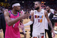 Miami Heat forward Caleb Martin (16) and Washington Wizards guard Jordan Goodwin (7) congratulate each other after the Heat beat the Wizards 110-107 during an NBA basketball game, Friday, Nov. 25, 2022, in Miami. (AP Photo/Wilfredo Lee)