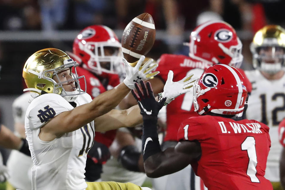 Notre Dame wide receiver Chris Finke (10) bobbles the ball as Georgia defensive back Divaad Wilson (1) makes an interception during the second half of an NCAA college football game, Saturday, Sept. 21, 2019, in Athens, Ga. Georgia won 23-17. (AP Photo/John Bazemore)