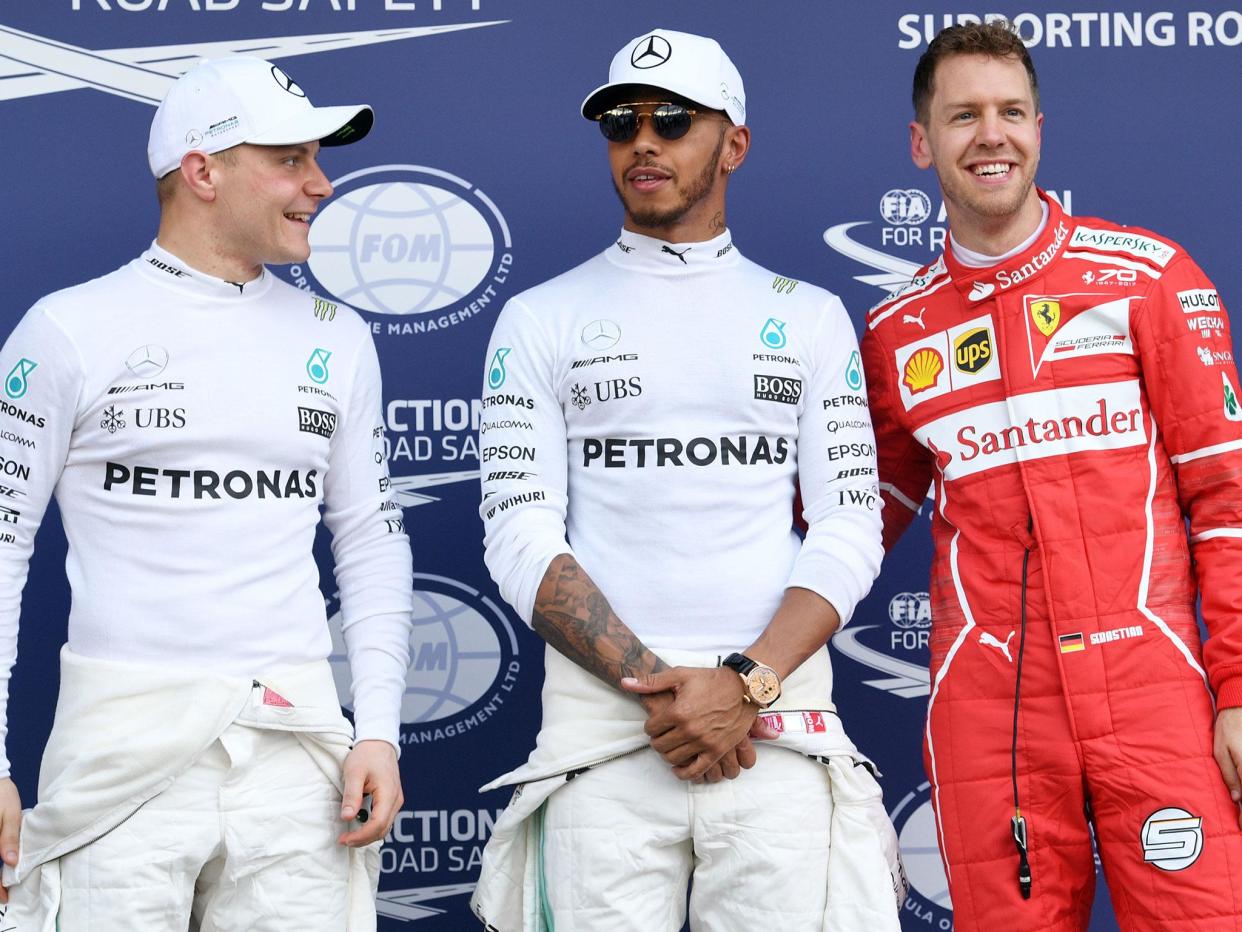 Lewis Hamilton (centre) took pole position for the Australian Grand Prix ahead of Sebastian Vettel (right) and Valtteri Bottas (left): Getty