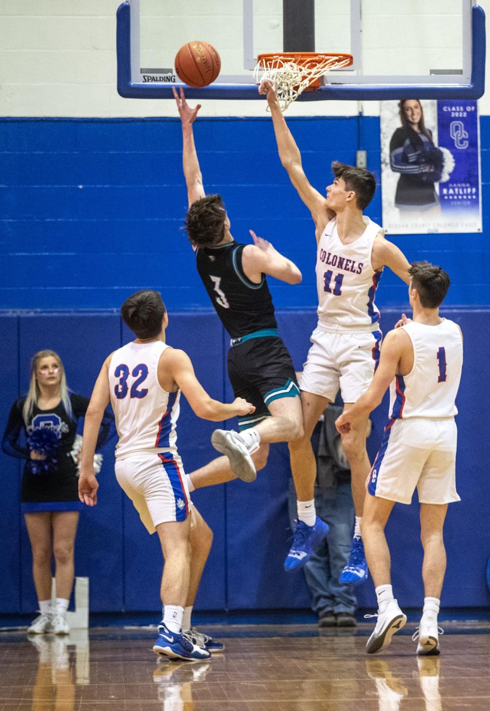 North Oldham's Ian Higdon (3) puts up a layup as Oldham County's Hayden Burgess (11) defends in the first half while defended by  on Friday night. Jan. 21, 2022