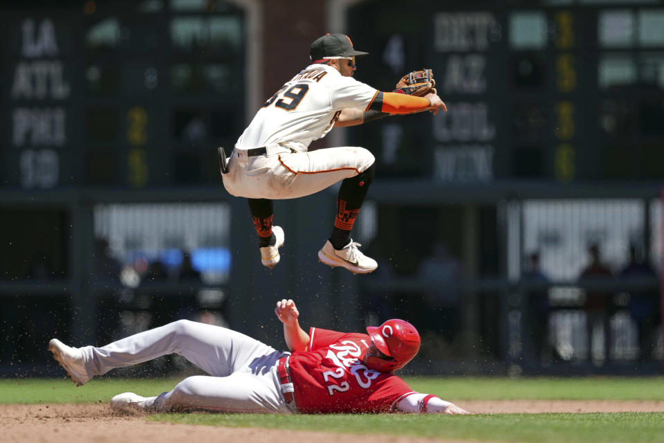 San Francisco Giants shortstop Thairo Estrada (39) jumps over Cincinnati Reds' Brandon Drury (22) after throwing the ball to first base to complete a double play during the sixth inning of a baseball game Sunday, June 26, 2022, in San Francisco, Calif. (AP Photo/Darren Yamashita)