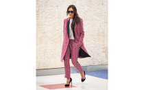 <p>Victoria doesn't need a catwalk to show off her latest collection. The former Spice Girl opted for an airport arrival to show off her new red and white printed suit, longline jacket, and lace top for her collection. </p>