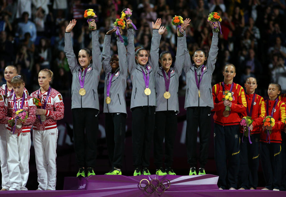 LONDON, ENGLAND - JULY 31: Jordyn Wieber, Gabrielle Douglas, Mc Kayla Maroney, Alexandra Raisman and Kyla Ross of the United States celebrate on the podium after winning the gold medal in the Artistic Gymnastics Women's Team final on Day 4 of the London 2012 Olympic Games at North Greenwich Arena on July 31, 2012 in London, England. (Photo by Cameron Spencer/Getty Images)