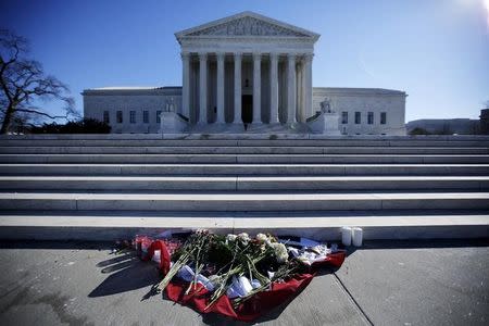 Flowers are seen in front of the Supreme Court building in Washington D.C. after the death of U.S. Supreme Court Justice Antonin Scalia, February 14, 2016. REUTERS/Carlos Barria