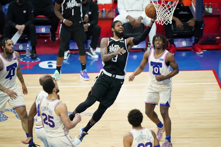 Los Angeles Clippers' Paul George (13) goes up for a shot during the first half of an NBA basketball game against the Philadelphia 76ers, Friday, April 16, 2021, in Philadelphia. (AP Photo/Matt Slocum)