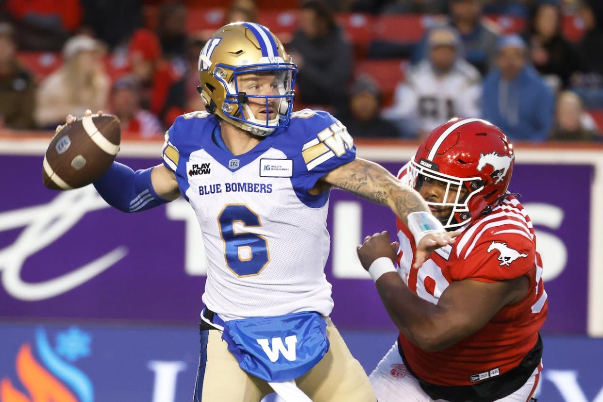 Calgary Stampeder T.J. Rayam, right, closes in on Winnipeg Blue Bombers quarterback Dru Brownas he looks for the pass on Aug. 18, 2023. (Larry MacDougal/The Canadian Press - image credit)