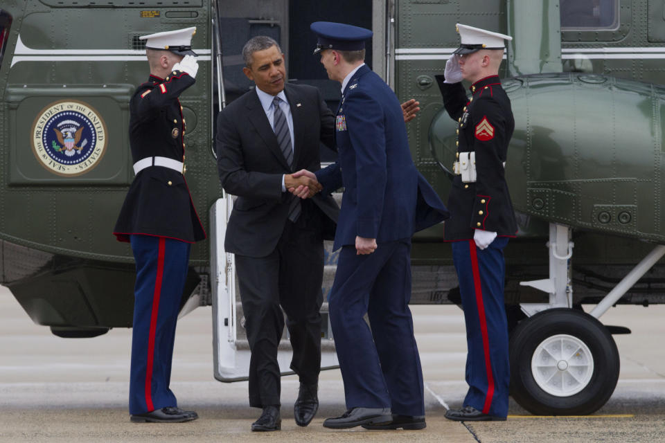 President Barack Obama is greeted by Air Force Col. Daniel Waters, vice-commander of Andrews Air Force Base, upon his arrival at Andrews Air Force Base, Md., Wednesday, Feb. 19, 2014, before traveling to Toluca, Mexico to participate in the seventh trilateral North American Leaders Summit Meeting, where he will meet with Canadian Prime Minister Stephen Harper and Mexican President Enrique Peña Nieto. This year's theme is “North American Competitiveness.”(AP Photo/Jacquelyn Martin)