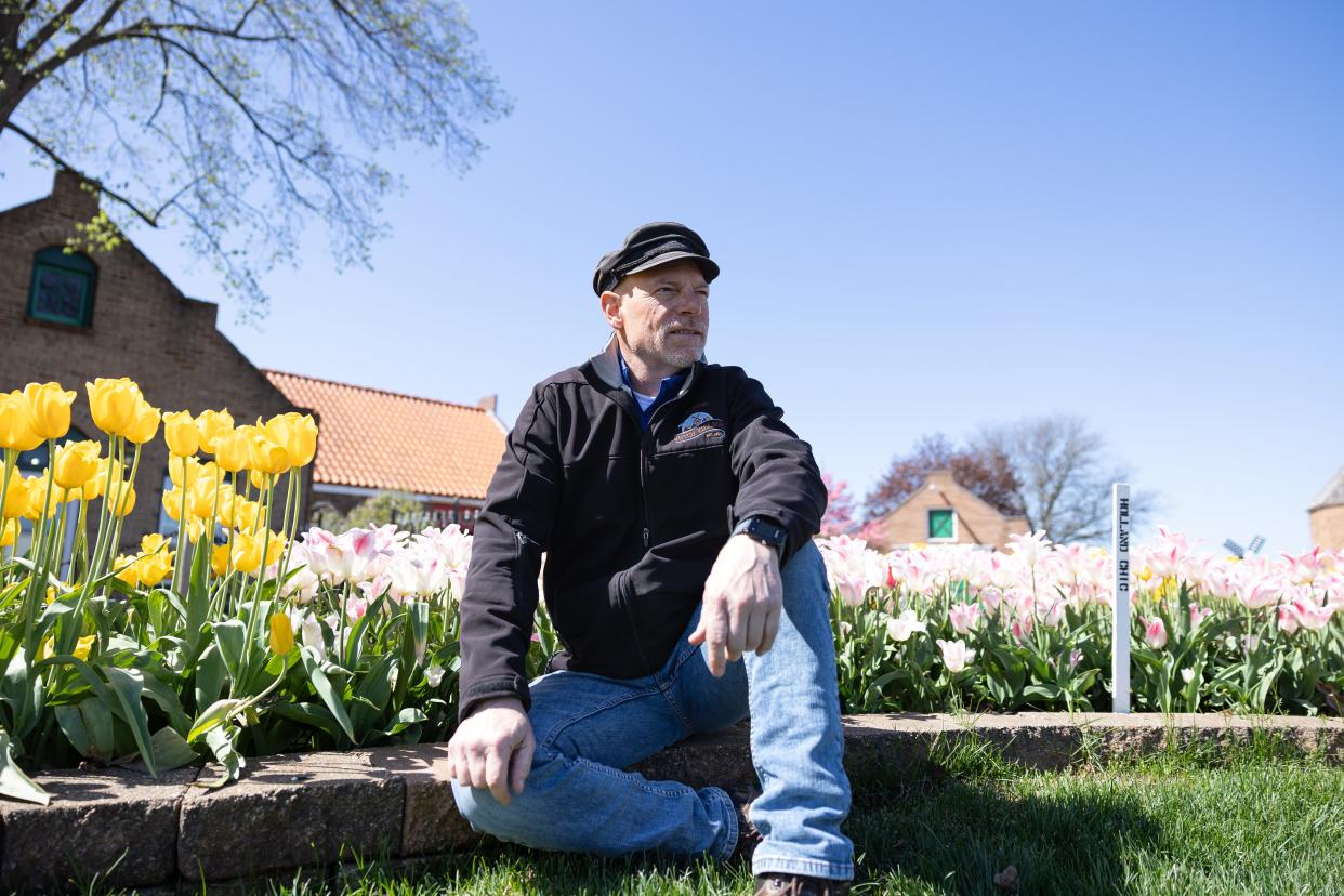 Joe Nelis poses as tulips start to blossom on April 30.