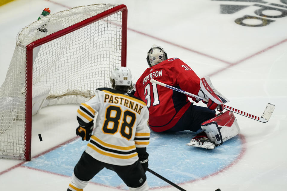 Washington Capitals goaltender Craig Anderson (31) cannot stop the winning goal by Boston Bruins center Brad Marchand (not shown) with Bruins right wing David Pastrnak (88) nearby during overtime of Game 2 of an NHL hockey Stanley Cup first-round playoff series Monday, May 17, 2021, in Washington. (AP Photo/Alex Brandon)