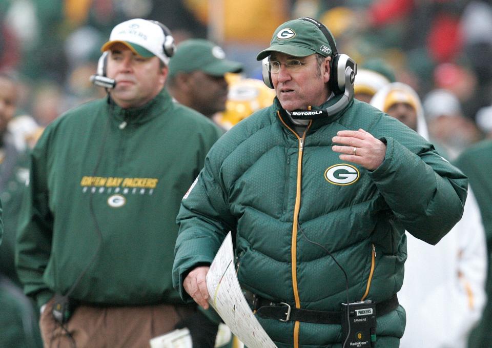 This Dec. 30, 2007 file photo shows Green Bay Packers defensive coordinator Bob Sanders, right, on the sidelines with coach Mike McCarthy, left, during the second half of an NFL football game against the Detroit Lions.