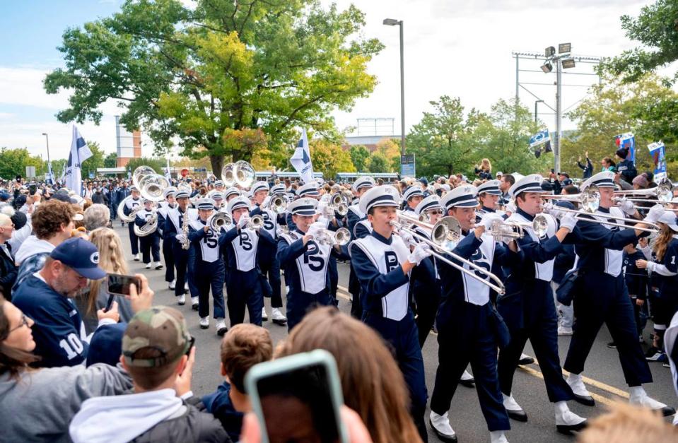 Members of the Penn State Blue Band leads the football team to Beaver Stadium for the game on Saturday, Sept. 24, 2022.