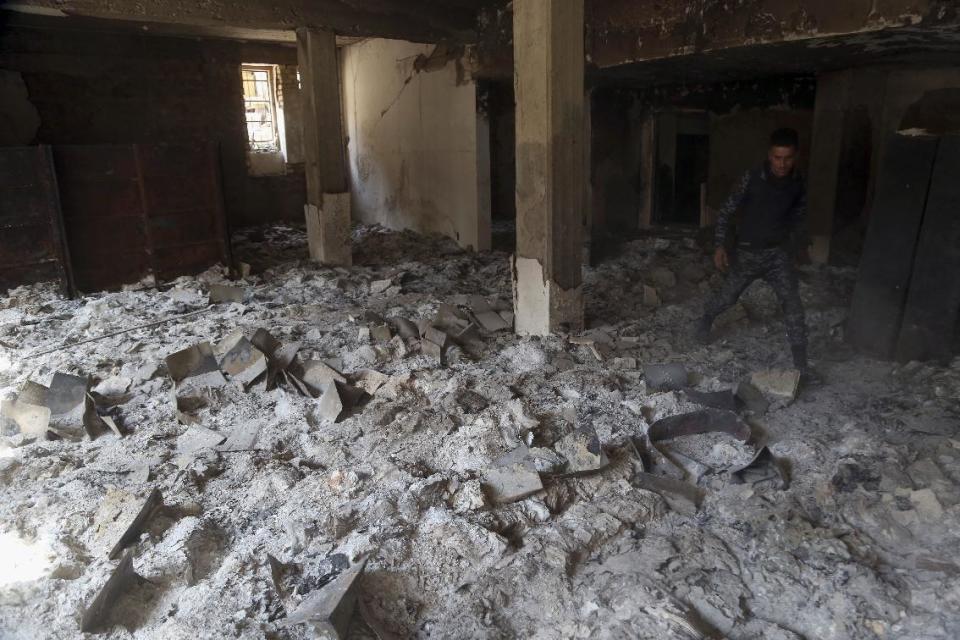 Burned ancient books and manuscripts are seen inside Mosul's heavily damaged museum. Most of the artifacts inside the building appeared to be completely destroyed. The basement level that was the museum's library had been burned. The floors were covered in the ashes of ancient manuscripts, in western Mosul, Iraq, Wednesday, March 8, 2017. (AP Photo/Khalid Mohammed)